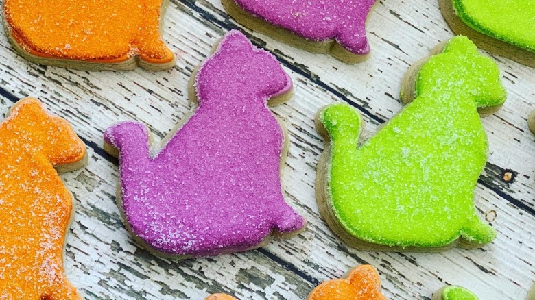 Cat cookies decorated with purple, green and orange sanding sugar