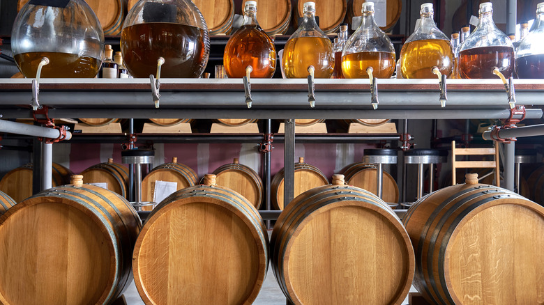 aged whiskey barrels at distillery