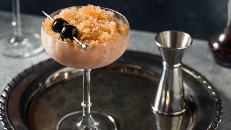 Bourbon slushie in glass on tray