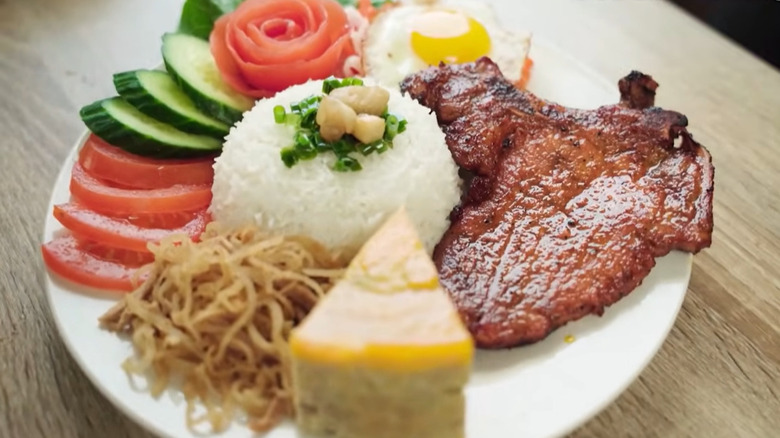 Grilled pork chop with rice, vegetables, and egg