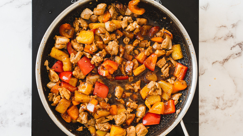 pineapple teriyaki chicken with peppers in pan