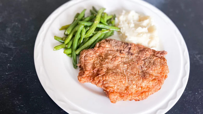 southern friend pork chop with green beans and mashed potatoes