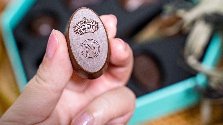 Hand holding Neuhaus chocolate