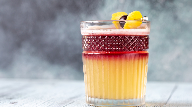 New York Sour with lemon and cherry garnish