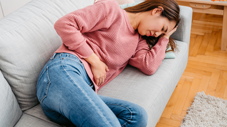 Woman holding stomach in pain