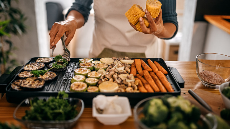 adding veggies to roasting pan