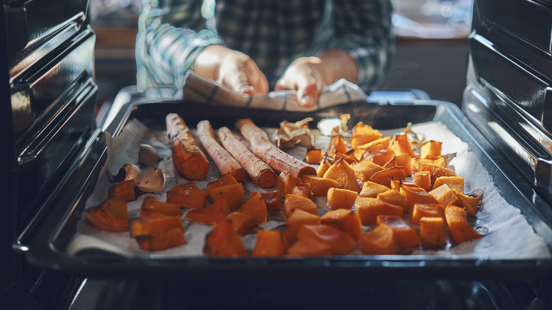 taking roasted root veggies out of the oven