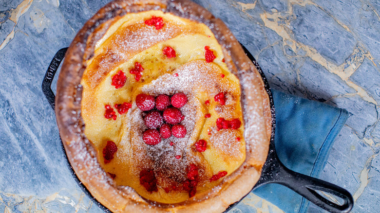 Dutch baby with raspberries and powdered sugar