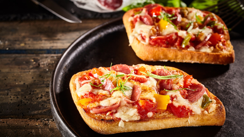 Pizzas on the surface of a cast-iron skillet