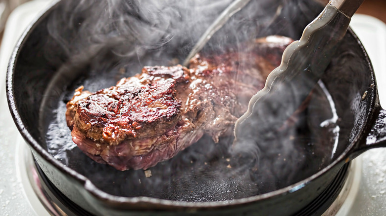 Steak searing in a cast iron skillet