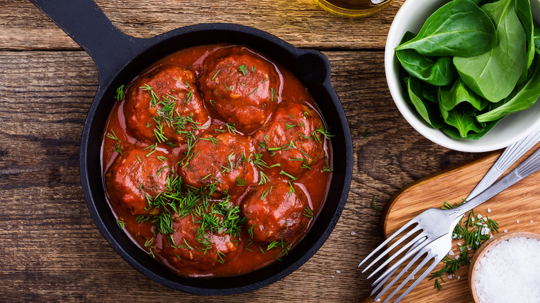 Meatballs and tomato sauce in a cast iron skillet