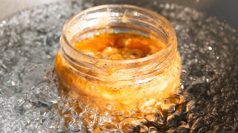 a mason jar sitting in a water bath