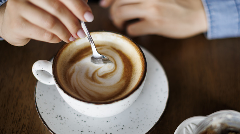 stirring cup of coffee