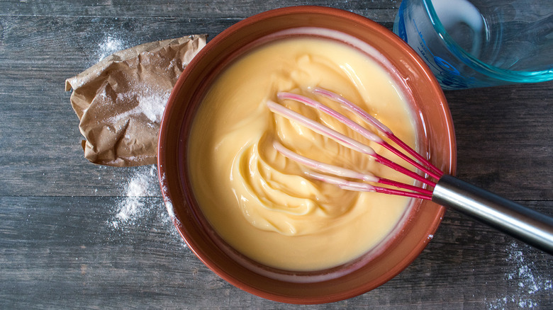 Instant pudding in bowl with whisk