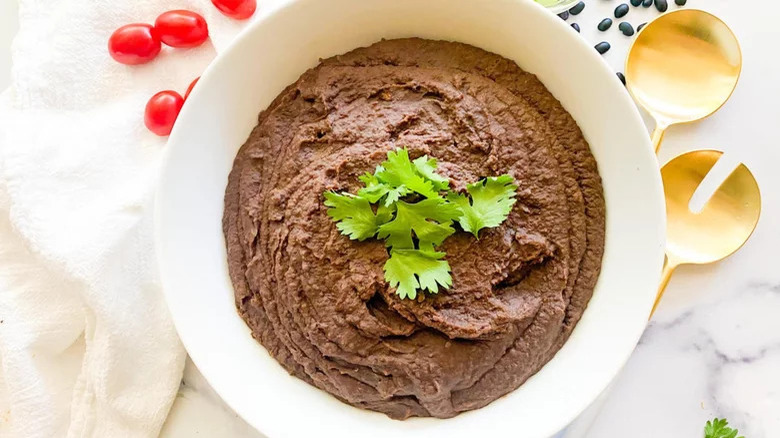 Refried black beans with garnish