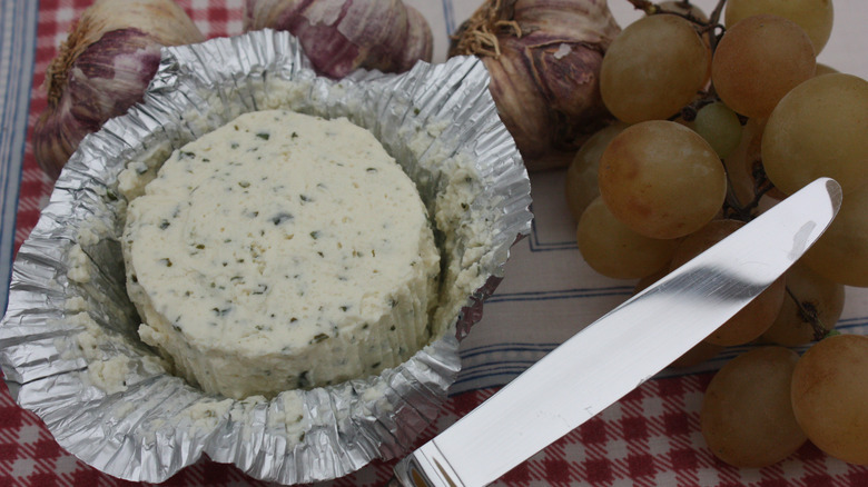 boursin cheese with knife and grapes