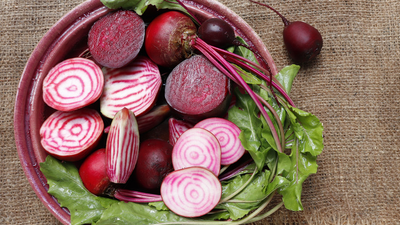 sliced beats in bowl with greens