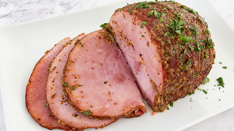 Sliced roasted ham joint with cilantro