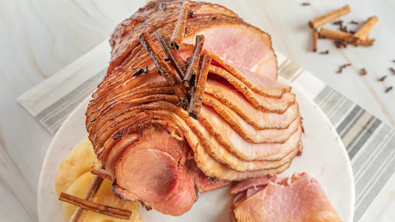 Baked spiral ham with cinnamon sticks and cloves