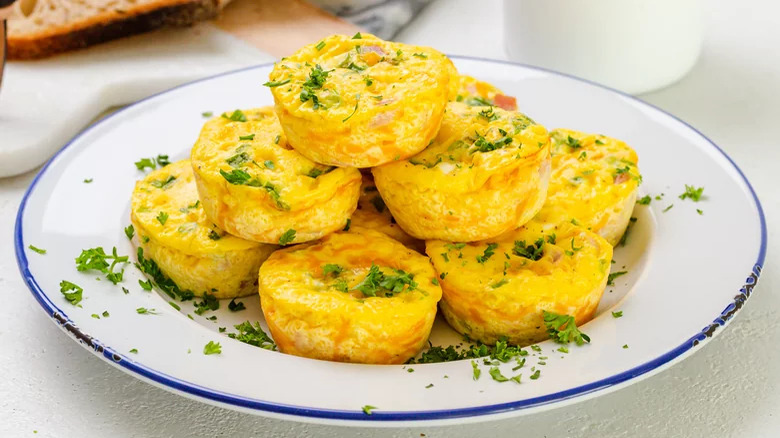 Crustless ham muffin quiches piled up on a plate