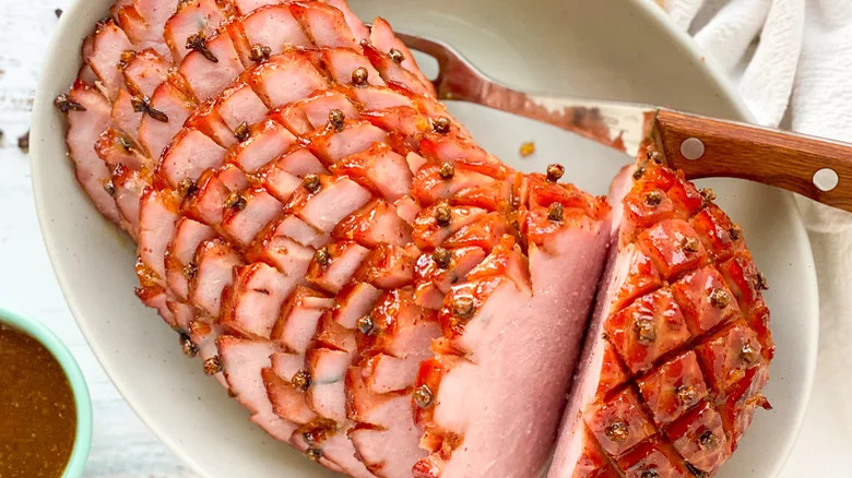 Easter ham sliced in a dish with cloves