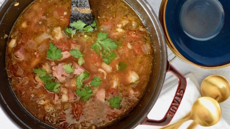 Ham and bean soup in a pot POV from above