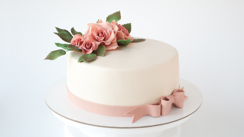 white wedding cake with pink roses