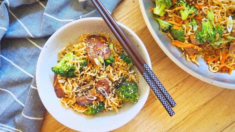 Bowls of noodles with beef and broccoli. 