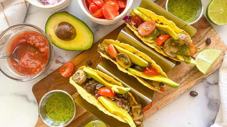 Hard tacos with mushrooms, avocado, and chimichurri sauce.