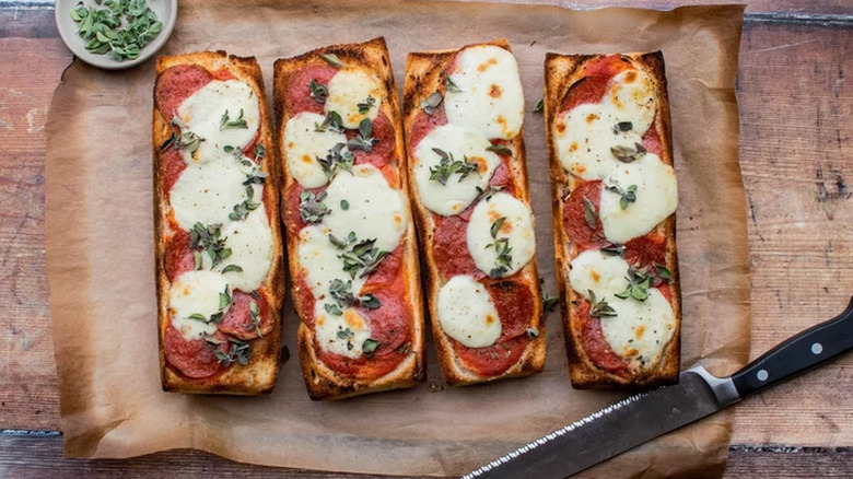 French bread pizzas with mozzarella, pepperoni, and herbs. 
