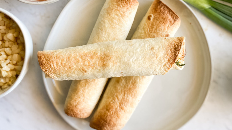 Tortillas rolled up with fillings and browned.