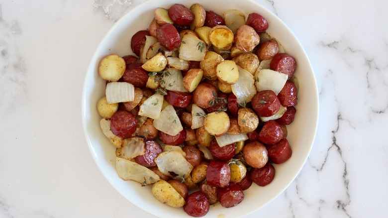 Overhead shot of browned potatoes and sliced sausage