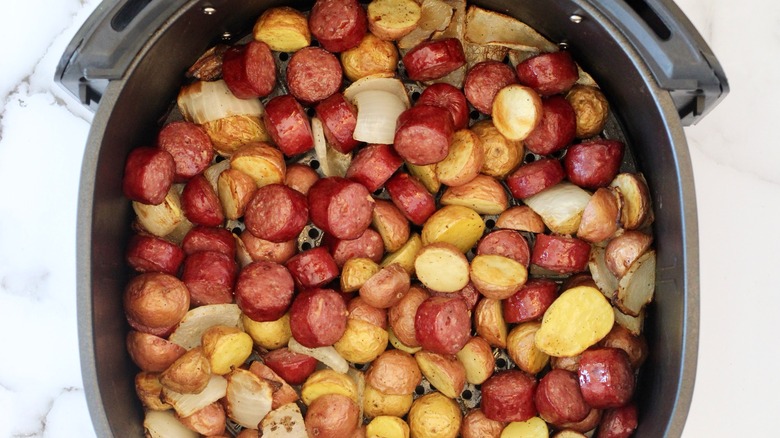 Sausage and potatoes in an air fryer basket