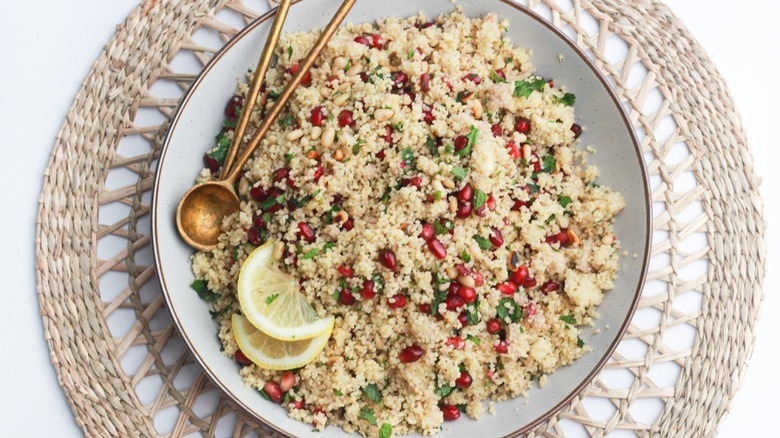 Pomegranate couscous with lemon wedge