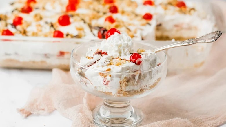 No-Bake Banana Split Cake in parfait dish with spoon