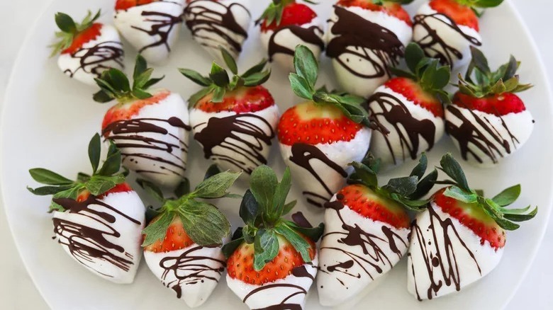 plate of yogurt-dipped strawberries with chocolate drizzle