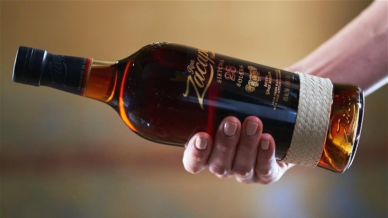 Ron Zacapa bottle in hand