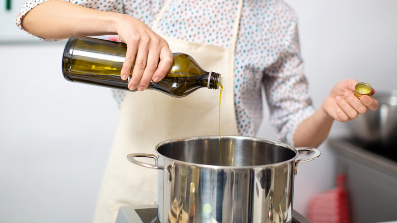 Olive oil being poured into a pot