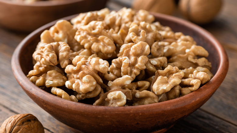 shelled walnuts in brown bowl