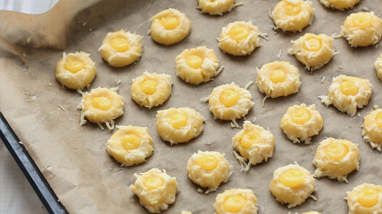 Cheesy thumbprint cookies on tray