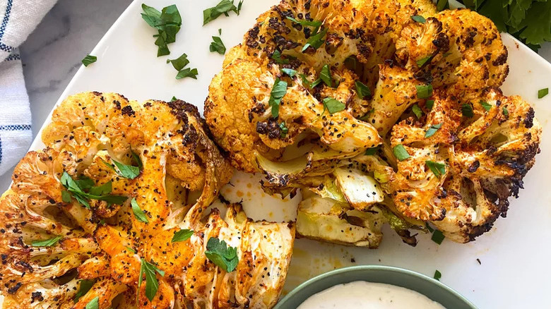 two cauliflower steaks on plate