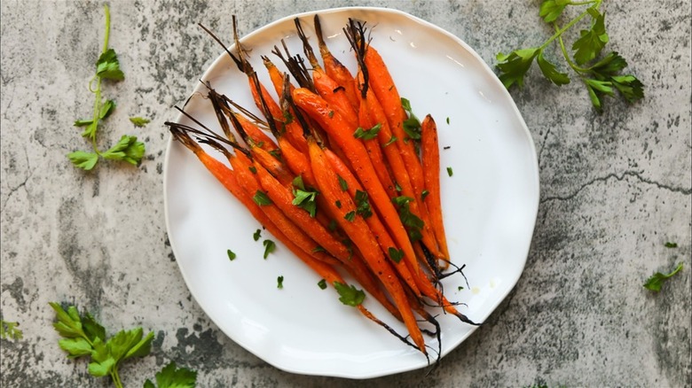 Plate of roasted carrots surrounded by parsley