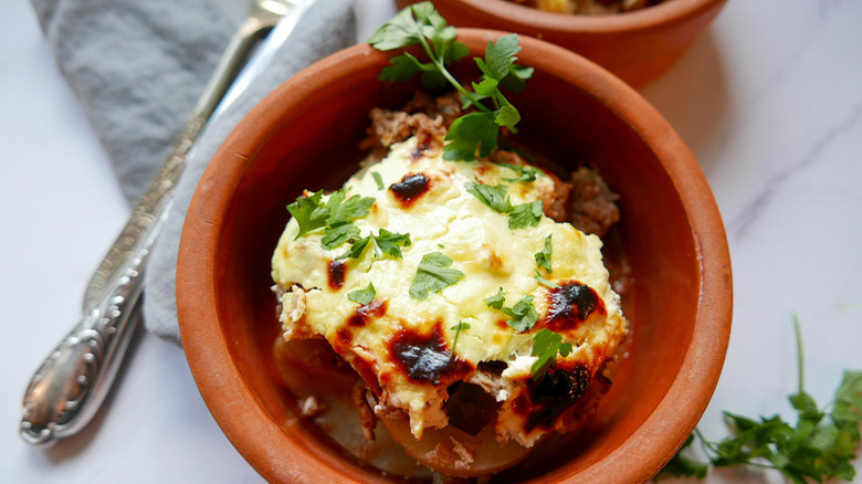 moussaka in orange-brown bowl