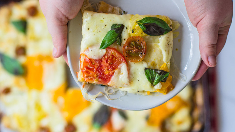 pizza on plate with hands