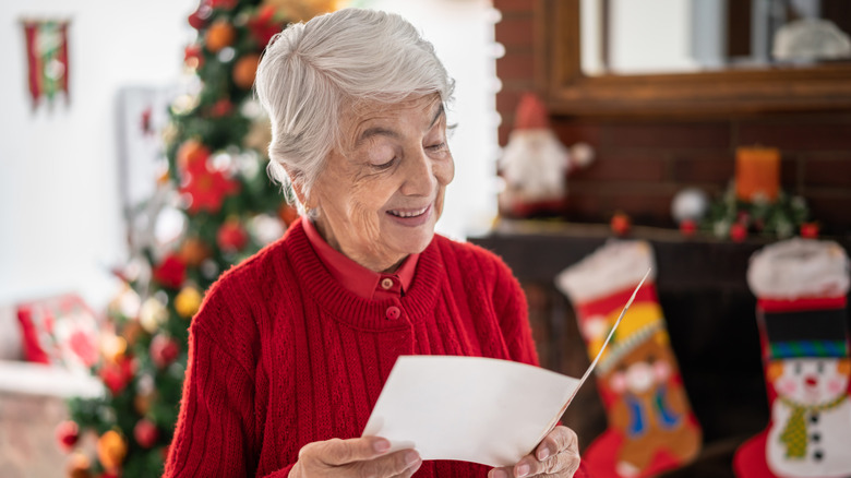 Elderly woman reading card