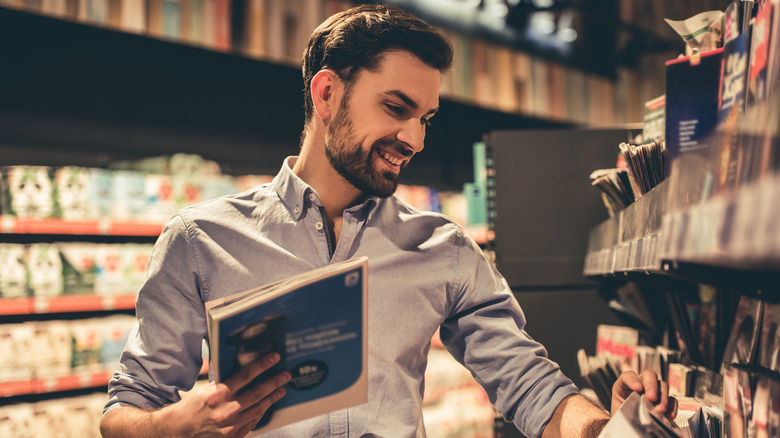 Man looking at magazines