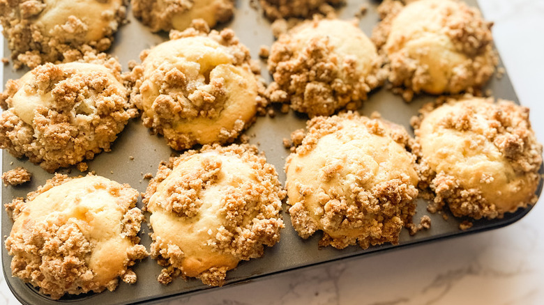 Muffin pan with streusel-topped baked muffins. 