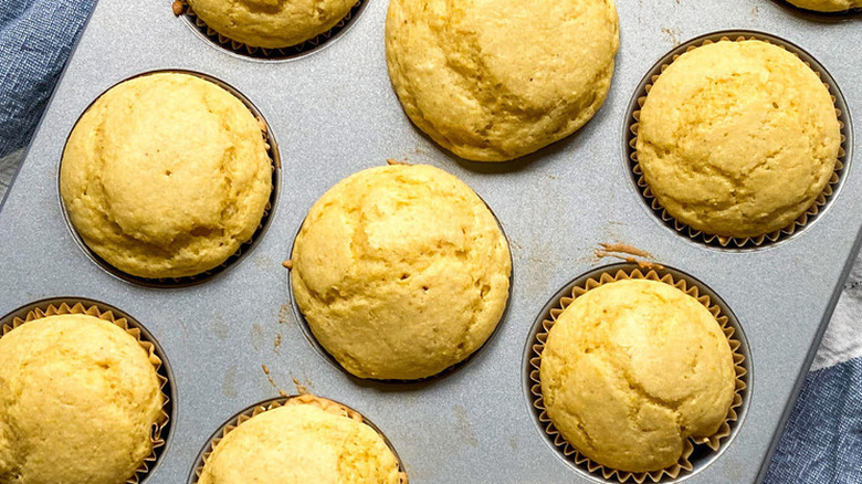 Baked cornbread muffins in a muffin pan.