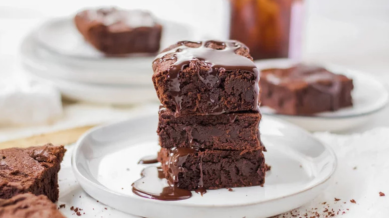 Stack of three, melty brownie squares.