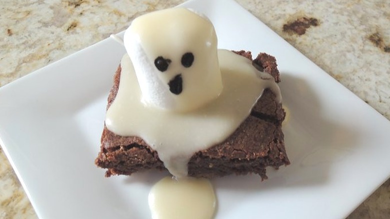 Brownie topped with glaze and a marshmallow.